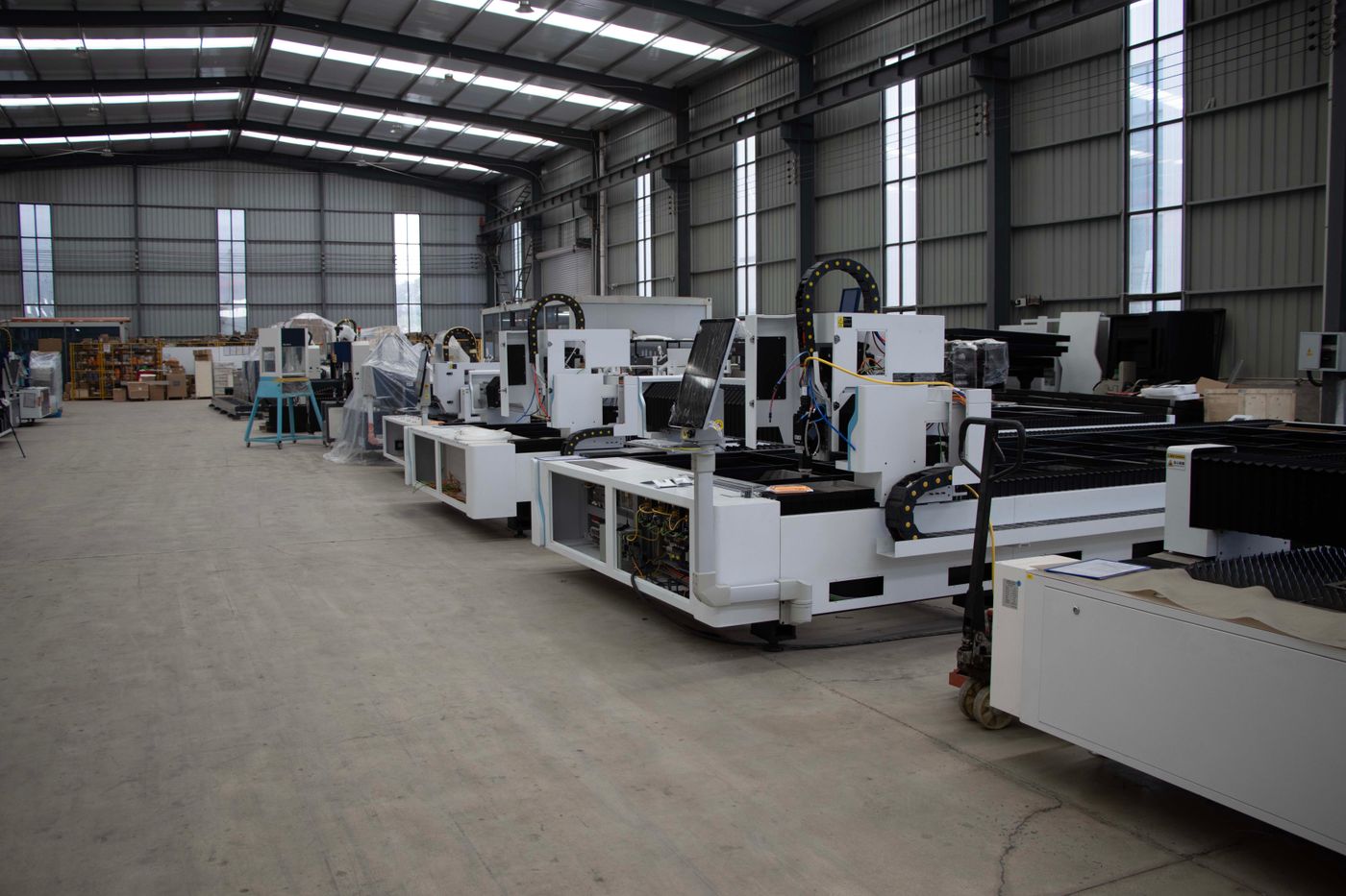 Rows of production machines on a modern factory floor.