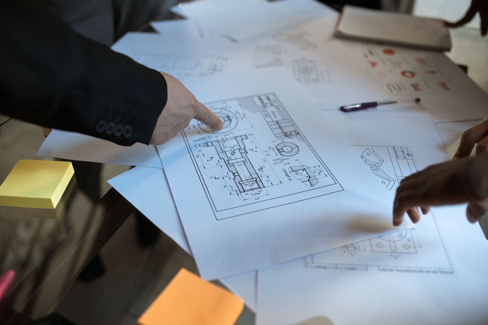 Engineers checking a technical drawing together.