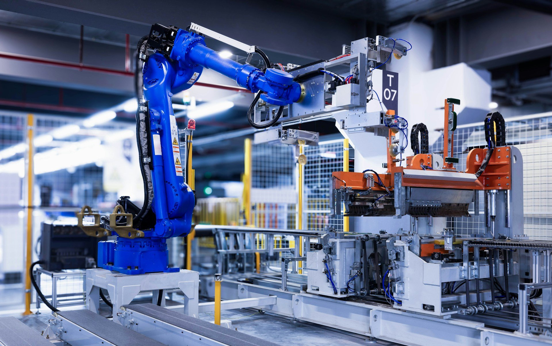 Industrial robot arm working in an automated production cell.