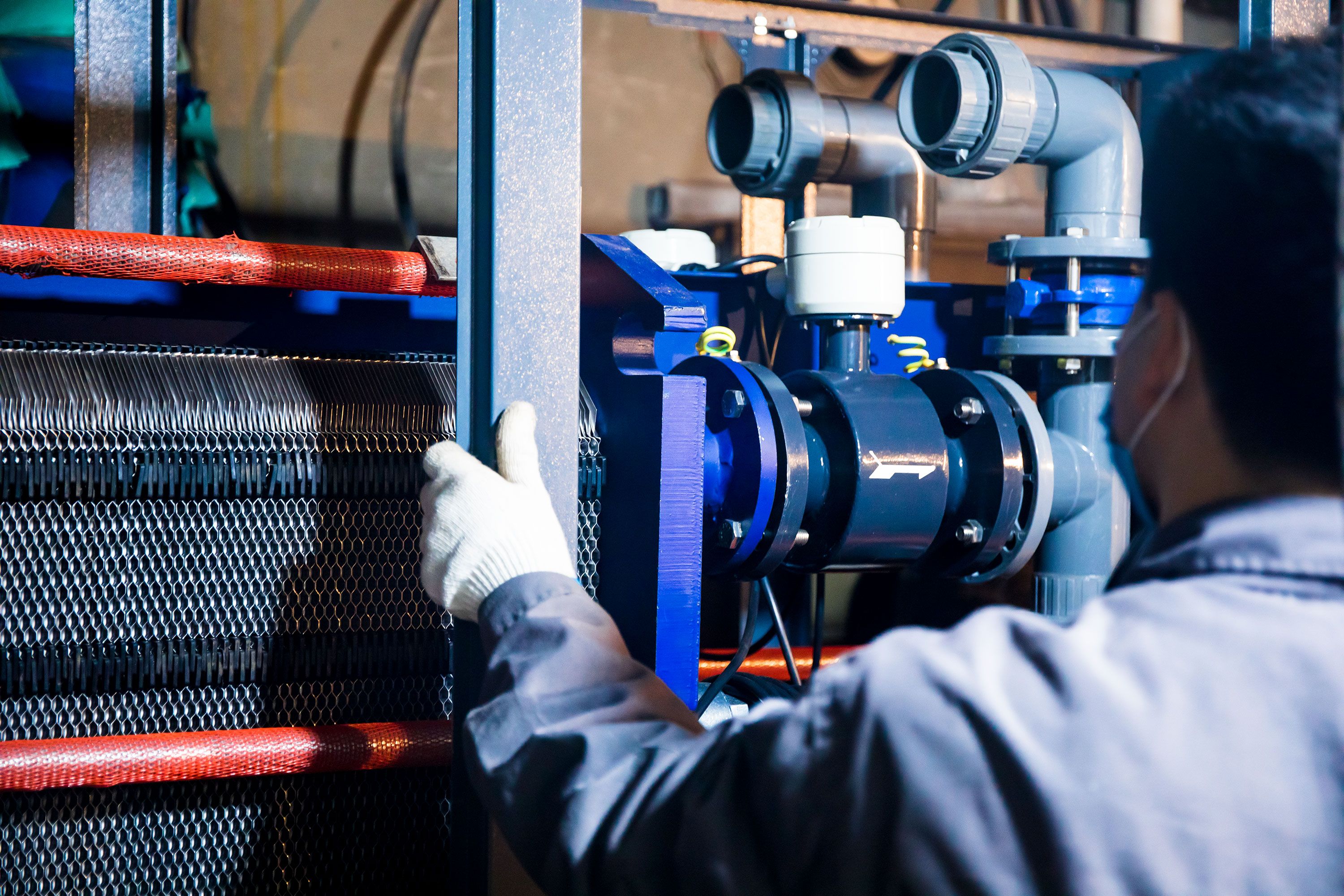 Technician checking industrial process equipment and sensors.